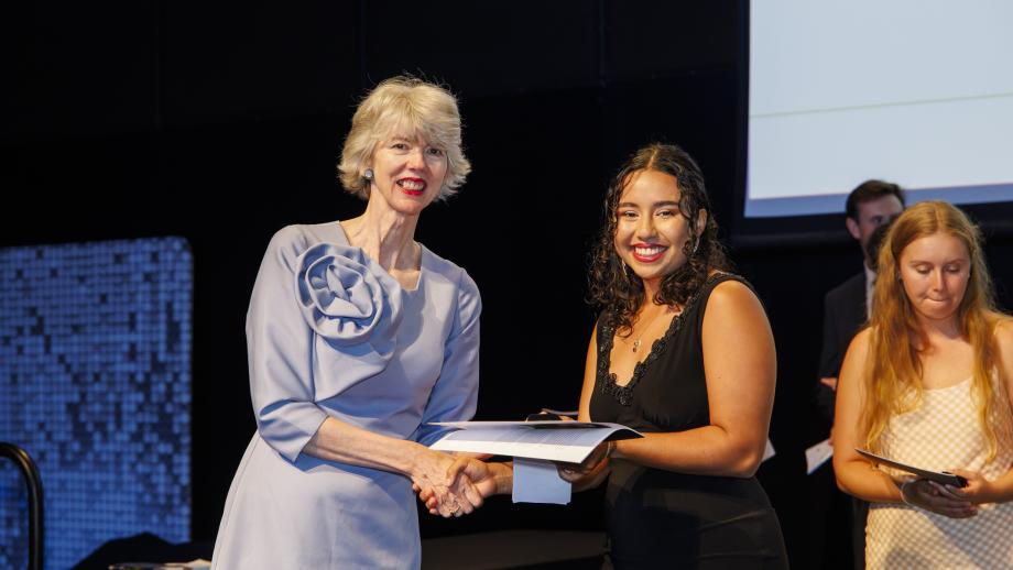 Louise Tuckwell presenting Olivia Taifalos with alumni pin